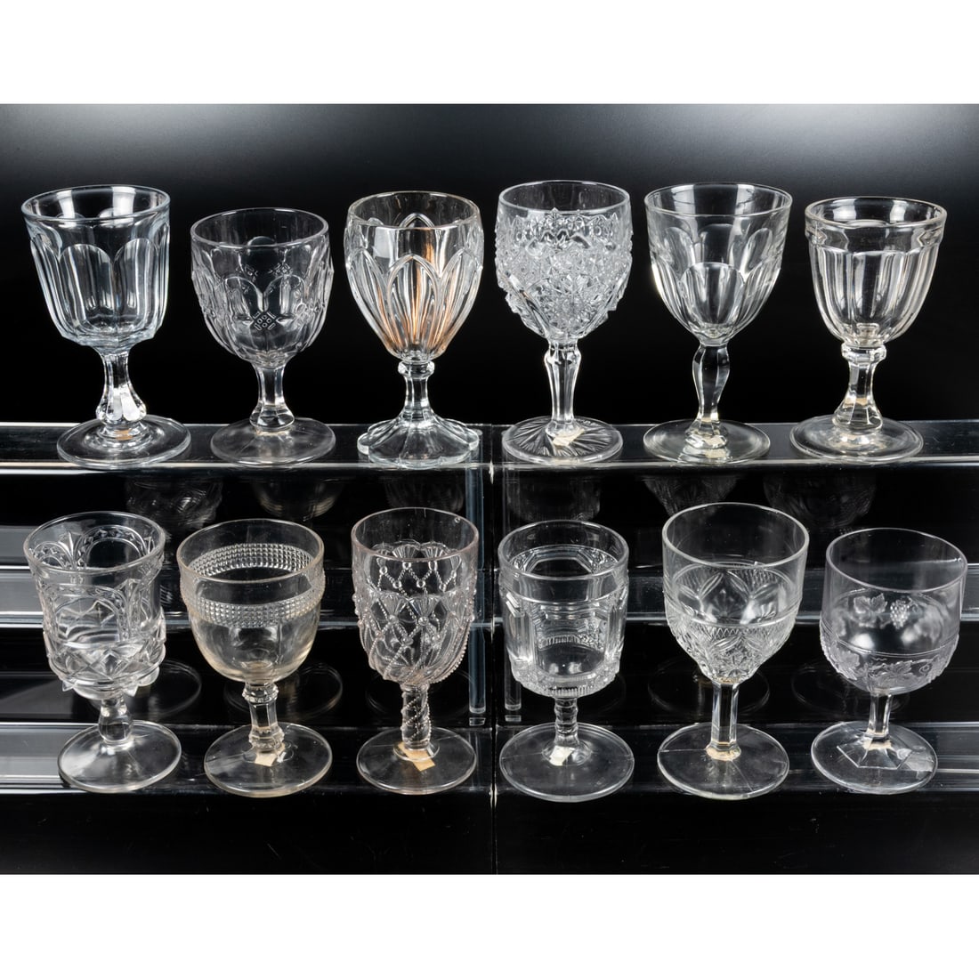 12 EAPG Pressed Glass Goblets: 12 EAPG Pressed Glass Goblets, late 19th - early 20th Century. Having two, three (tri-mold) or four mold joints. Various Makers. Tallest: 6 1/2 in.