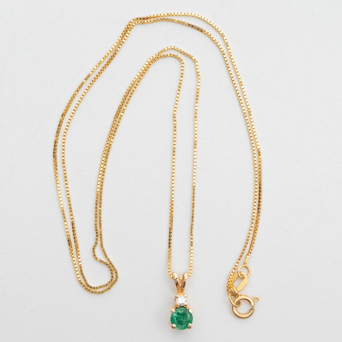14K Yellow Gold Necklace with 14K Yellow Gold Emerald and Diamond Pendant: 14K Yellow Gold Necklace with 14K Yellow Gold Emerald and Diamond Pendant, The boxchain necklace is 18 inches long by 0.50 mm thick. Marked 14K. The pendant is set with one round cut emerald