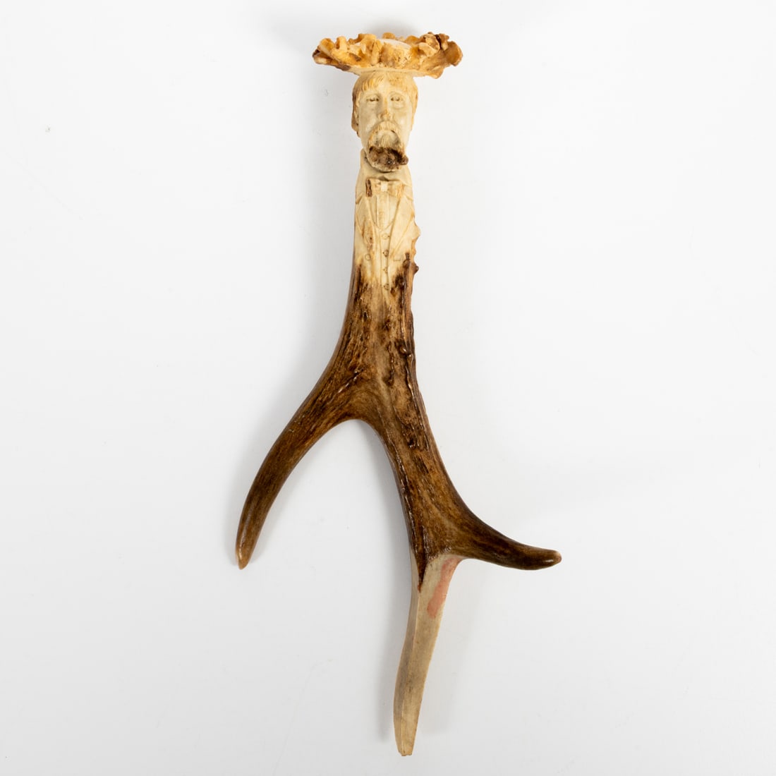 A Folk Art Hand Carved Antler Letter Opener: A Folk Art Hand Carved Deer Antler Letter Opener, Early 19th Century, Signed "SB", depicting a bearded man with suit jacket, vest and bow tie. H: 8 W: 4 D: 1 5/8 in.