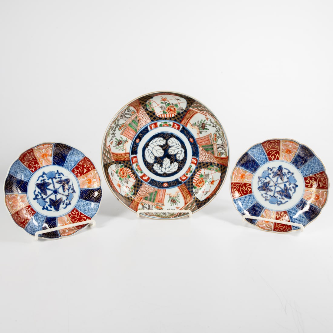 Three Japanese Imari Plates: Three Japanese Imari Porcelain Plates, Late Meiji Period. Comprising a charger and two small plates Charger, Dia: 12 in. Plates, Dia: 8 3/8 in.