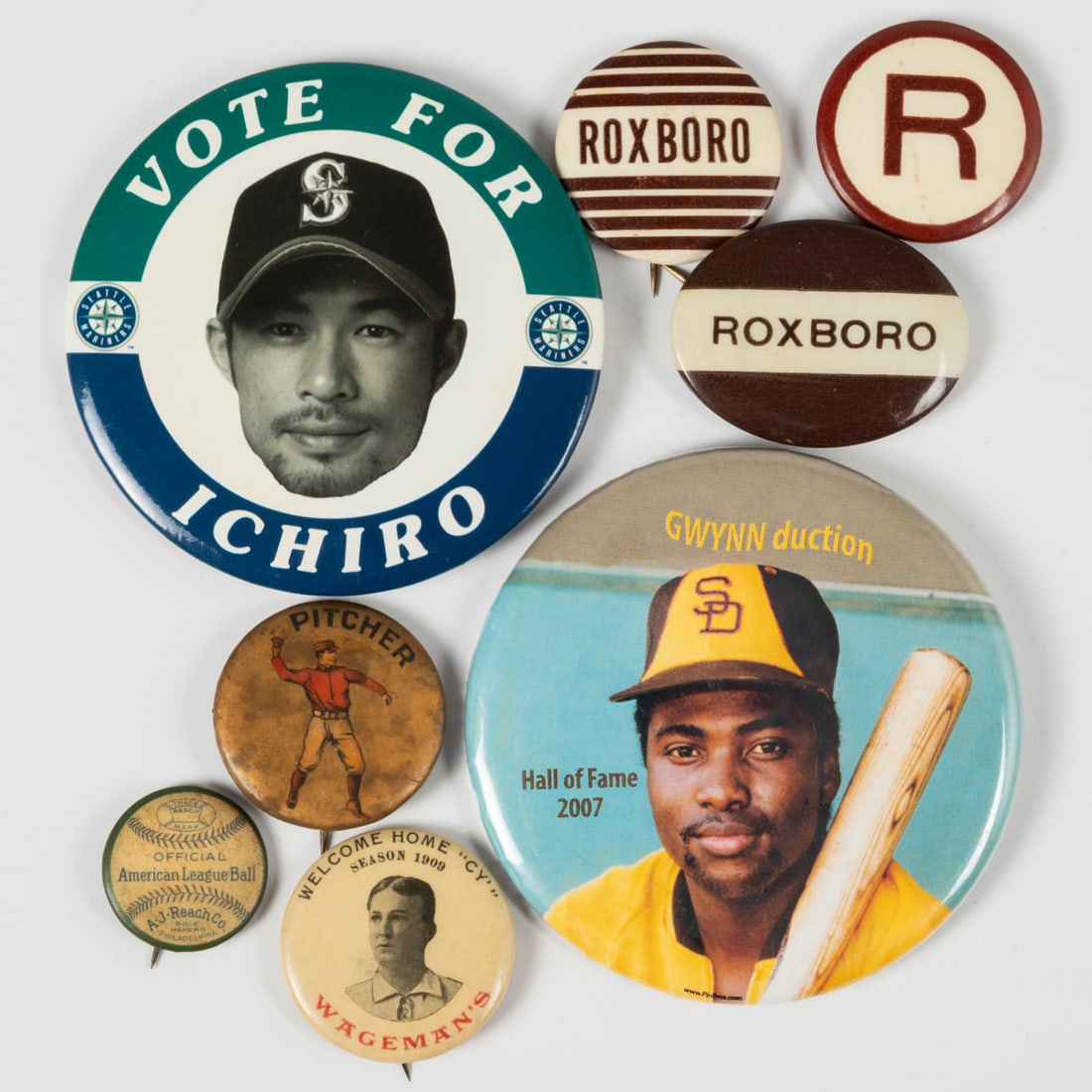 Eight Baseball Themed Pinbacks: Eight Baseball Themed Pinbacks, 20th Century, Comprising eight pinbacks: three Roxboro, a Pitcher, an Ichiro Suzuki, a Tony Gwynn, an American League Ball, and one Cy Young. Largest Pinback, Dia: 3 in