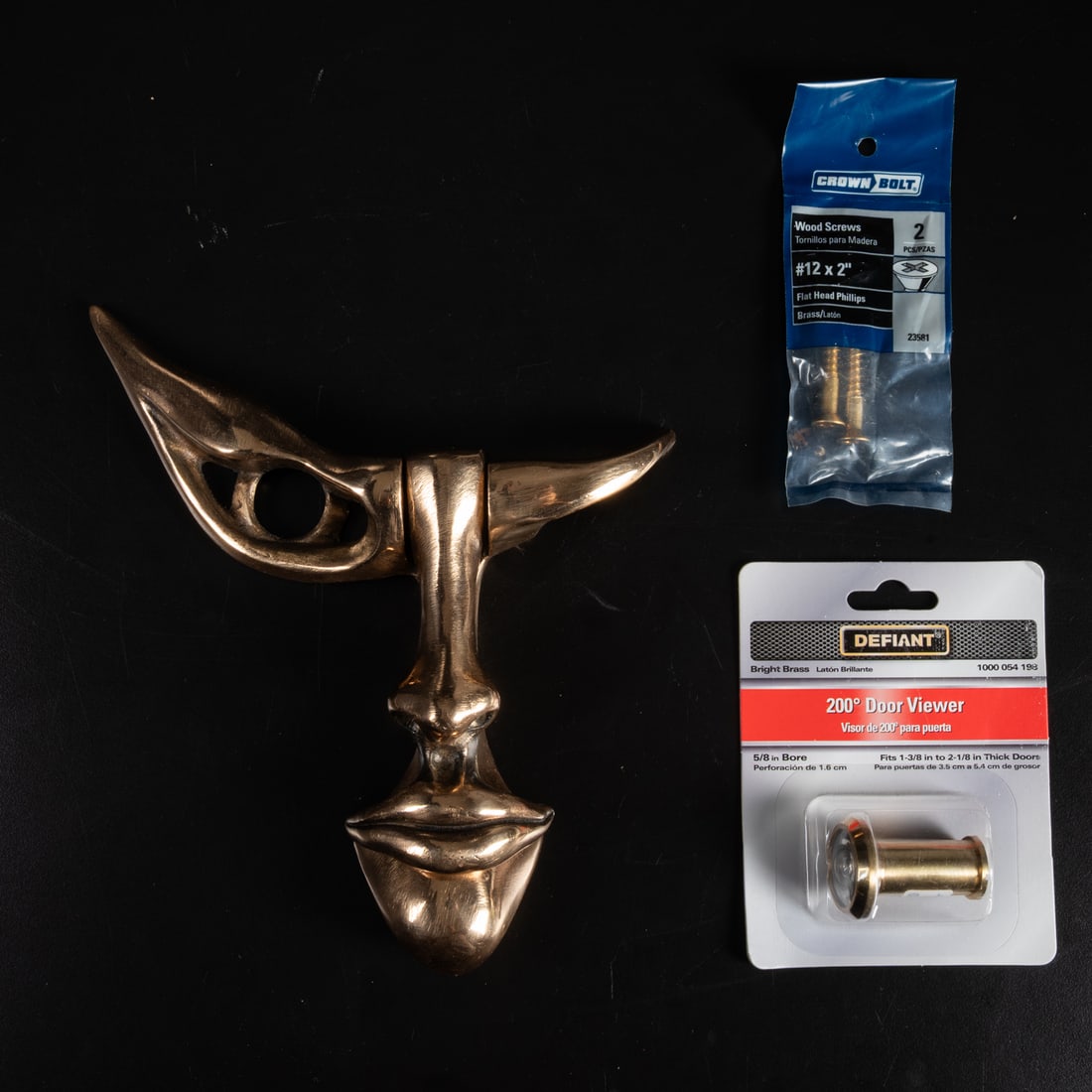Marte Cellura (American, b. 1951): Marte Cellura (American, b. 1951) The Door Guardian, Bronze door knocker, Signed on base piece behind nose. Having a door viewer and two wood screws.