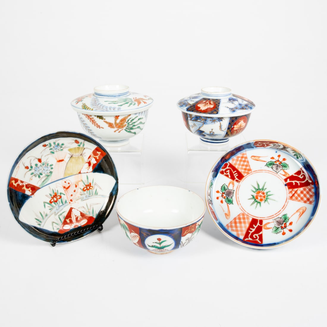 Five Japanese Imari Decorative Items: Five Japanese Imari Porcelain Decorative Items, Late Meiji Period. Comprising two covered bowls, two plates and a uncovered bowl Plates, Dia: 6 1/4 in.
