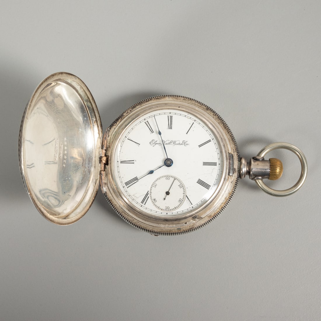 A Elgin Sterling Silver Pocket Watch: A Elgin National Watch Company Sterling Silver Pocket Watch, 19th/20th Century, Size 18 Pocket Watch. The outer case is marked coin. Case, Dia: 2 1/4 in.