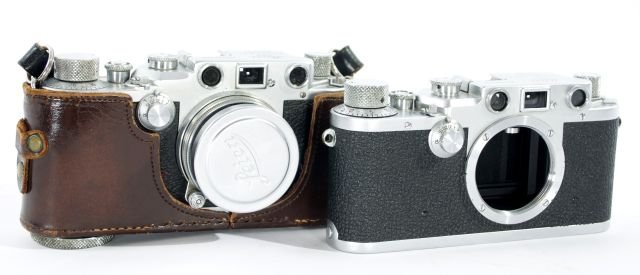 A Pair of Leica Rangefinder Cameras,: A Pair of Leica Rangefinder Cameras, One IIIc circa 1943 marked No. 394350 with 50 mm lens and in original case. One IIc circa 1948-51 marked No. 448374 without lens. Other Notes: *** Please inquire f
