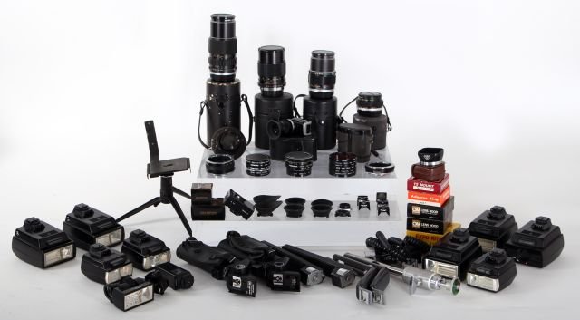 A Miscellaneous Collection of Olympus Camera Equipment: A Miscellaneous Collection of Olympus Camera Accessories and Equipment, 20th Century, Including manuals, cases, and lenses. Other Notes: *** Please inquire for shipping estimate prior to bidding. Ship