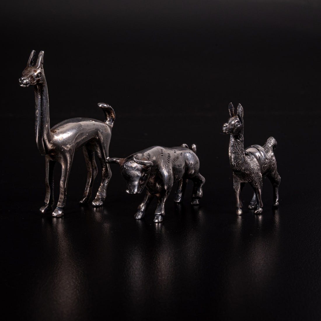 Three Sterling Silver Animal Figures: Three Sterling Silver Animal Figures, 20th Century, Comprising two llamas and a bull. The two llamas are with 925 and one illegible mark. Total Approx. Weight, 5 Troy Oz. Largest Llama, L: 1 1/2 x W: