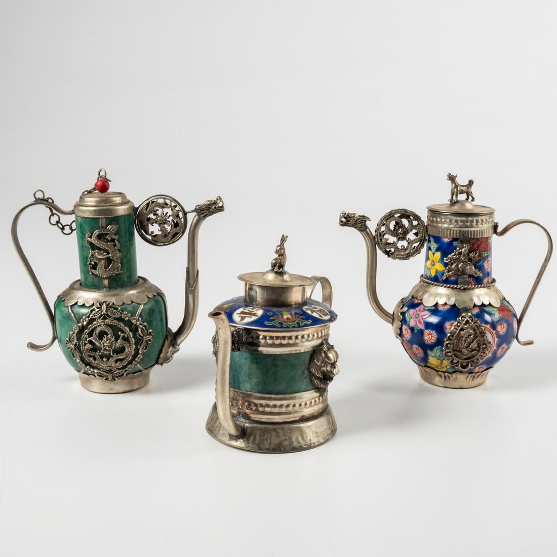 Three Chinese Silver Tea Pots: Three Chinese Silver, Porcelain, Enamel and Soapstone Tea Pots, Qing Dynasty (1875 - 1908), With dog and rabbit finials. Tallest dims, H: 4 3/4 x W: 5 x D: 2 3/4 in.