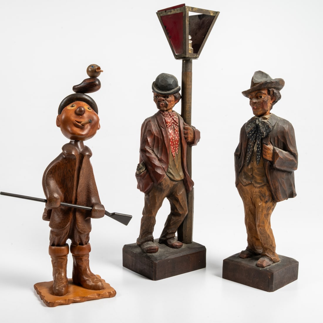 Two German Whistler Automations: Two German Karl Griesbaum Whistler Automations, 20th Century, Together with a Italian carved hardwood duck hunter. Undersides of the Karl Griesbaum figures are marked Germany, and the underside of the