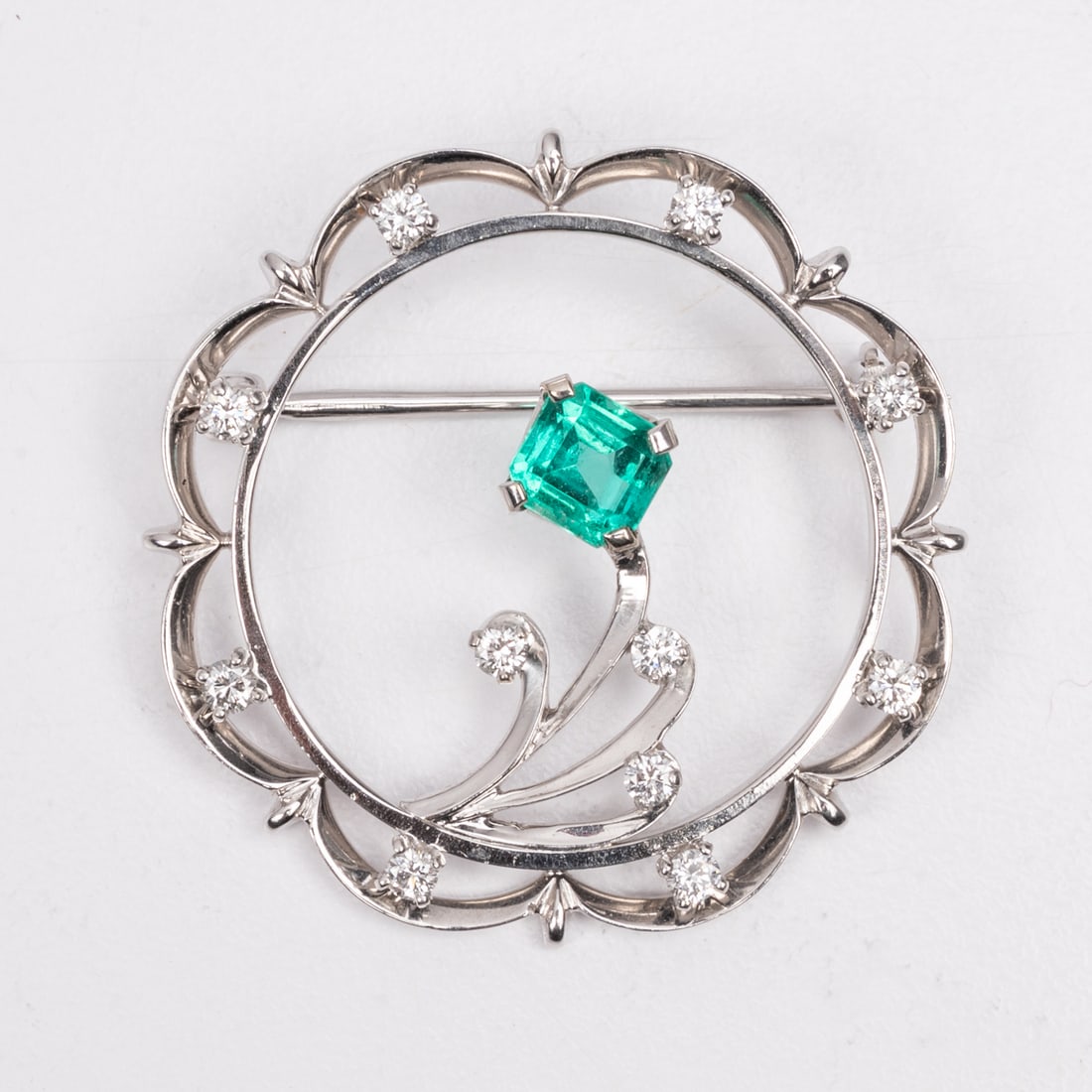 A 14kt White Gold, Tourmaline and Moissonite Brooch: A 14kt White Gold, Tourmaline and Moissonite Brooch, Set with one square cut green tourmaline stone, approx. 0.40 pts and eleven (11) round cut moissonite stones approx. 0.01 to 0.02 pts each. Marked 