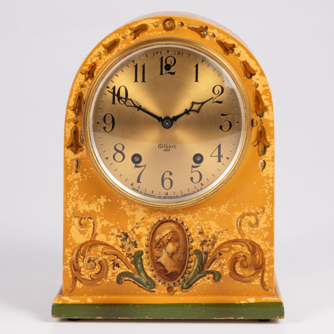A Gilbert Clock Co. Mantel Clock: A Gilbert Clock Co. Painted Wood Mantel Clock, 20th Century, Underside is marked with "Made in USA" H: 8 1/2 W: 6 1/2 D: 3 5/8 in.