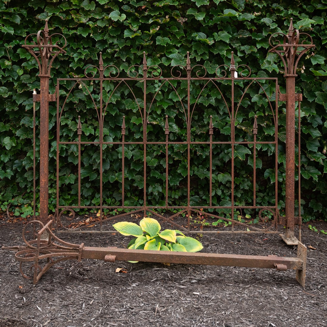 A Victorian Wrought Iron Gate: A Victorian Wrought Iron Gate, With three wrought iron pillar posts. Posts, H: 50 x W: 8 x D: 8 in. Gate, H: 42 x W: 50 in.