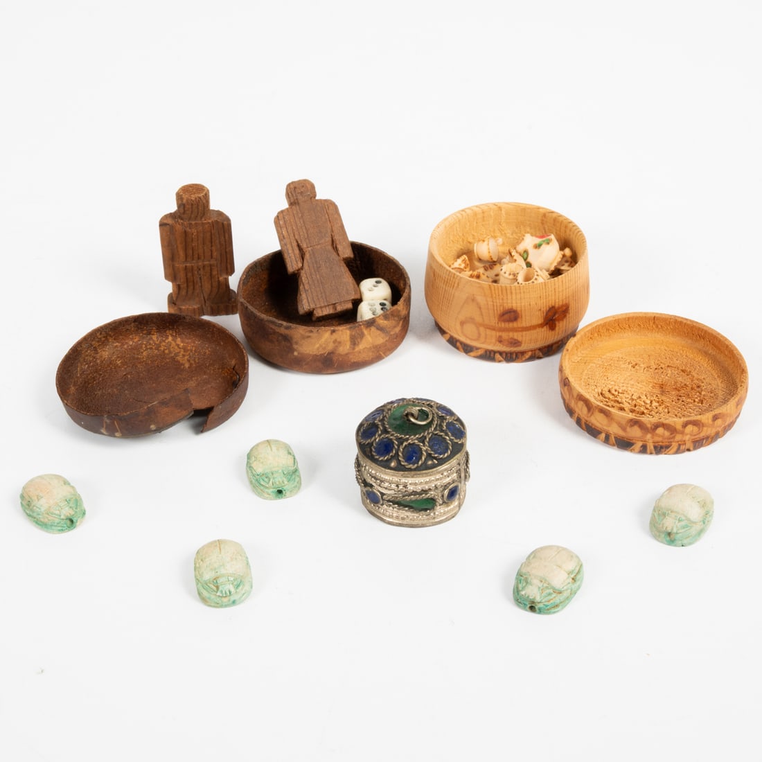 Egyptian and Spanish Decorative Objects: Egyptian and Spanish Decorative Objects, Comprising five Egyptian carved scarabs. a silvered and enamel box, two painted and burnt wood boxes with carved figures, a pair of dice and a miniature tea