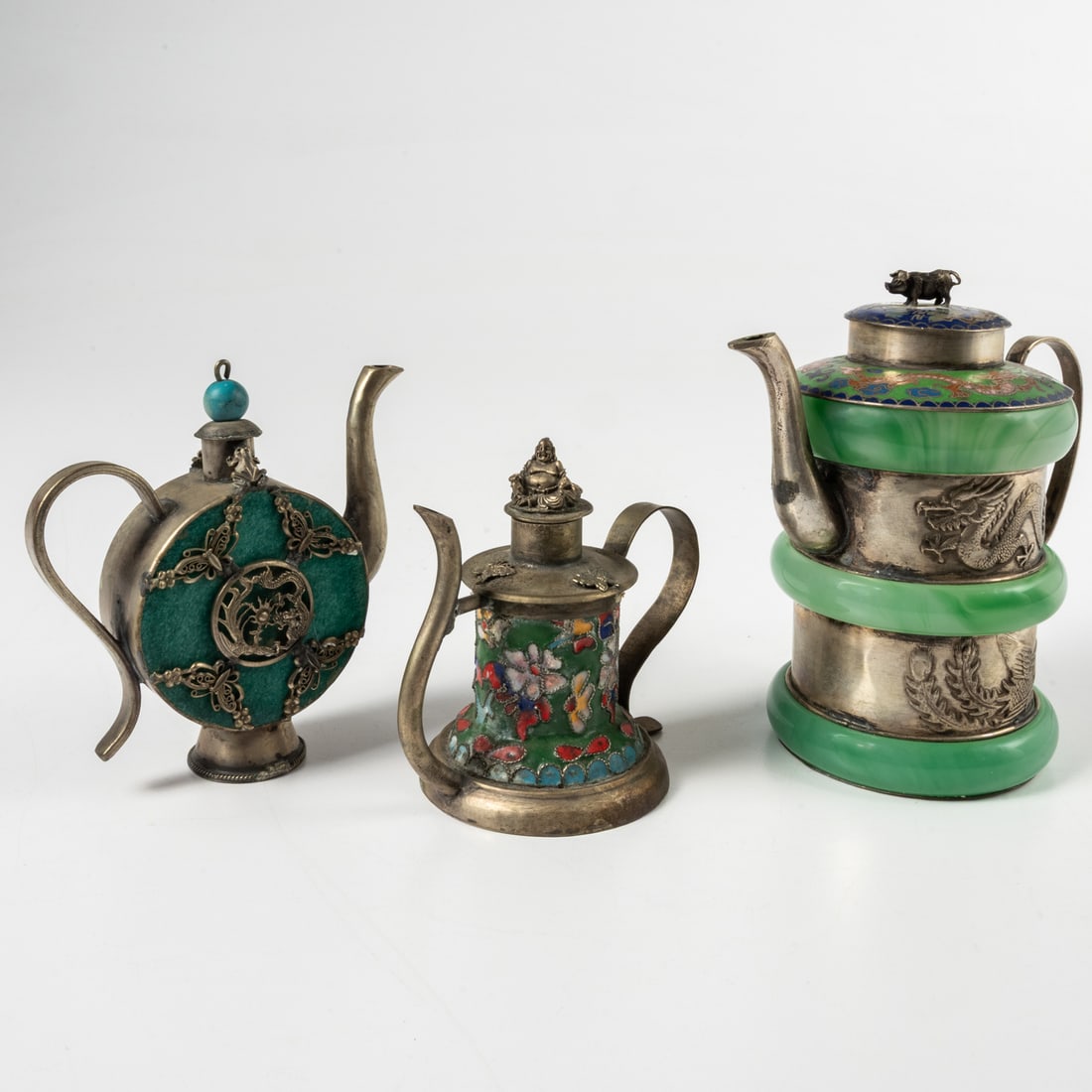 Three Chinese Silver Tea Pots: Three Chinese Silver, Enamel, Glass and Soapstone Tea Pots, Qing Dynasty (1875 - 1908), With Pig and Buddha finials. Tallest dims, H: 5 1/4 x W: 5 x D: 3 in.