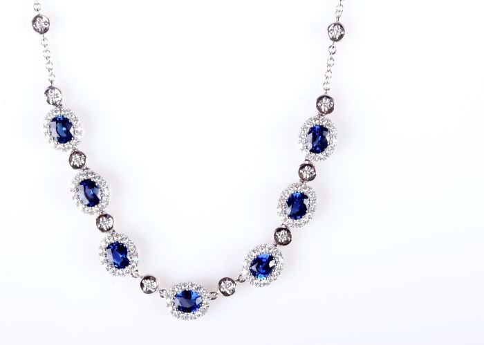 A Gregg Ruth 18kt. White Gold, Blue Sapphire and: A Gregg Ruth 18kt. White Gold, Blue Sapphire and Diamond Necklace, Having seven sapphire and diamond clusters, and twelve diamonds set in round bezels. One hundred and sixteen shared prong set round b