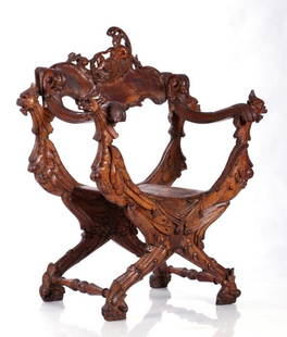 A Venetian Carved Fruitwood Savonarola Chair in the: A Venetian Carved Fruitwood Savonarola Chair in the Style of Luigi Frullini, 19th Century. Dimensions: h: 39 x w: 32 x d: 16 in.