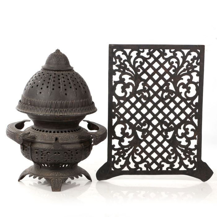 A Vintage Cast Iron Central Oil Gas Stove, 20th: A Vintage Cast Iron Central Oil Gas Stove, 20th Century, Together with a vintage iron decorative panel. Dimensions: h: 22 1/2 x dia: 13 1/3 in.