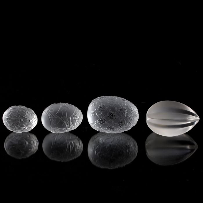 A Group of Four Lalique Frosted Glass Egg Form: A Group of Four Lalique Frosted Glass Egg Form Paperweights, 20th Century, Including the Cigales (cicada) motif, Coccinelles (ladybug) motif, Grillions (grasshopper) motif and a contemporary form. Eac