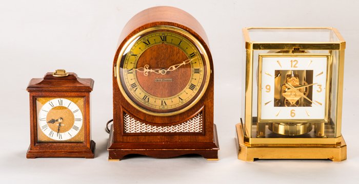 A Le Coultre & Cie. (Swiss) Brass and Glass Atmos: A Le Coultre & Cie. (Swiss) Brass and Glass Atmos Clock, 20th Century, Together with two Seth Thomas mahogany and brass mantle clocks. Largest dimensions: h: 11 x w: 8 1/2 x d: 6 in.