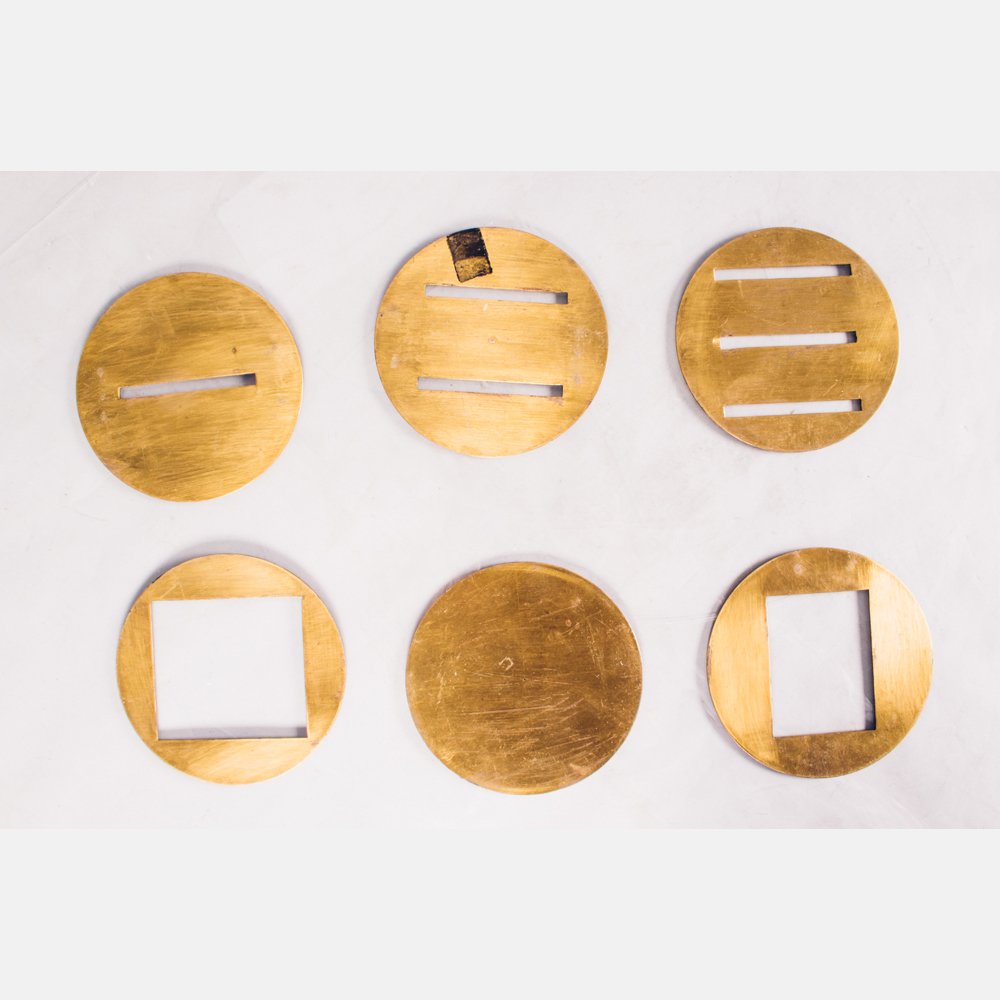 A Set of Six Brass Disk Masks, 20th Century. (1 of 1)