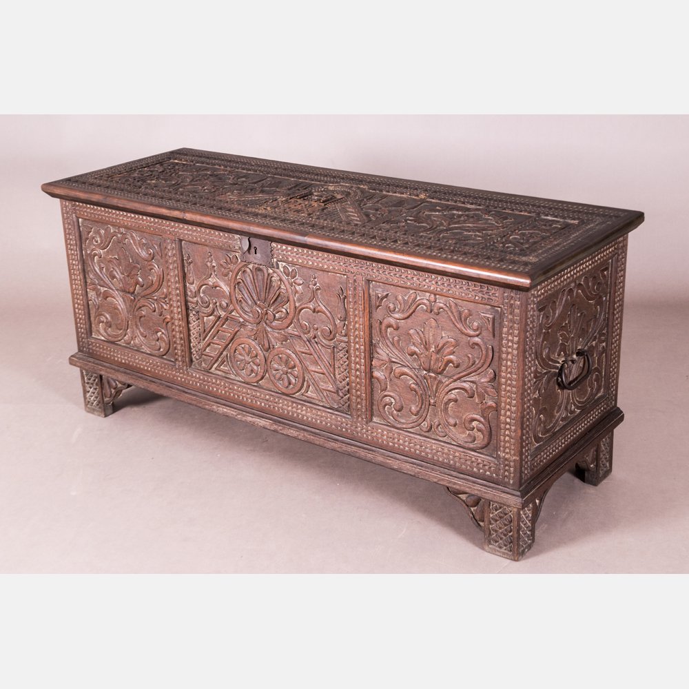 A Charles I Style Heavily Carved Walnut Chest,: A Charles I Style Heavily Carved Walnut Chest, 19th/20th Century. Having wrought iron fittings. H: 26 1/2 W: 58 D: 21 1/2 in.