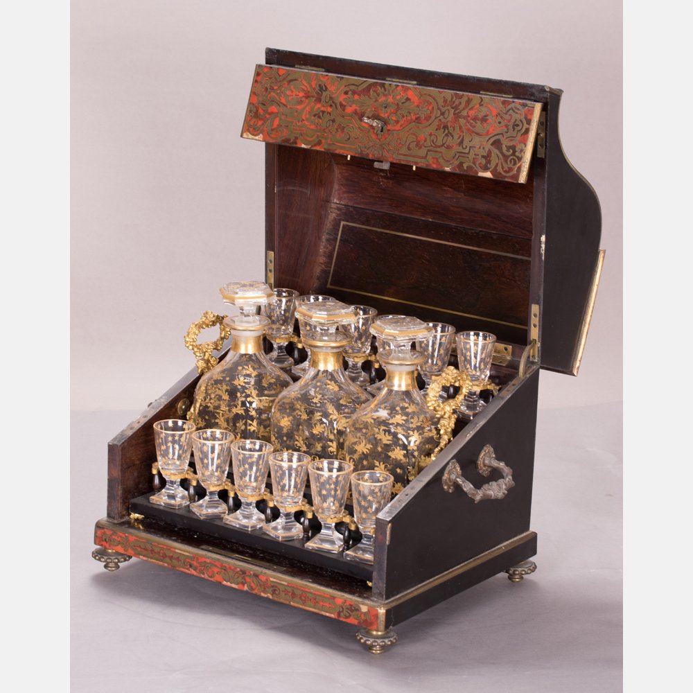 A French Boulle Inlaid Tantalus, 20th Century.: A French Boulle Inlaid Tantalus, 20th Century. Having three gilt decorated stoppered decanters and eleven cordials. H: 11 W: 13 D: 10 in.