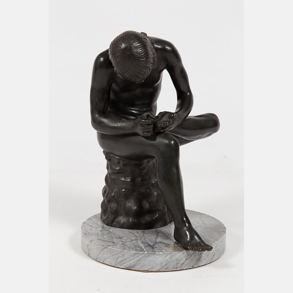 An Italian Patinated Bronze Model of Spinario,19th/20th: An Italian Patinated Bronze Model of Spinario,19th/20th Century, Cast after the antique, it portrays a nude, seated boy bending forward to remove a thorn from his raised left foot H: 19 D: 13 in. From