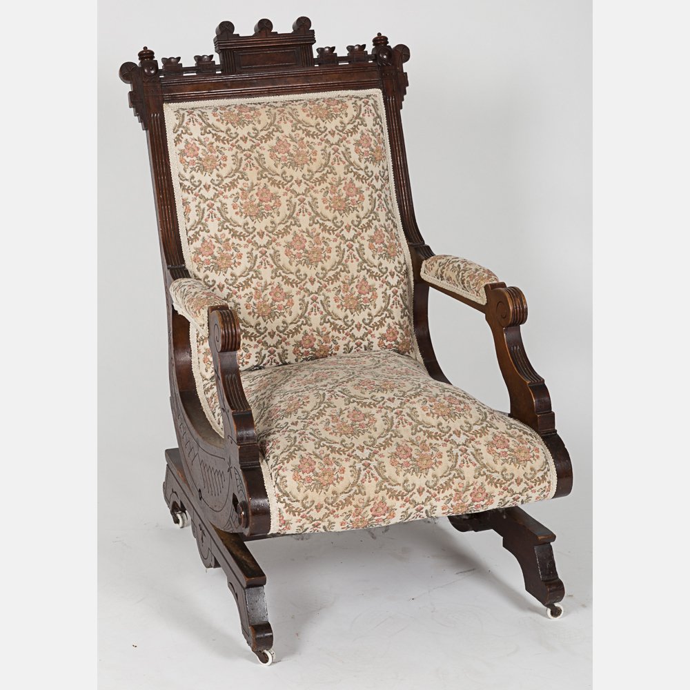 An Eastlake Style Carved Walnut Rocking Chair, 20th: An Eastlake Style Carved Walnut Rocking Chair, 20th Century. H: 37 W: 20 D: 30 in.