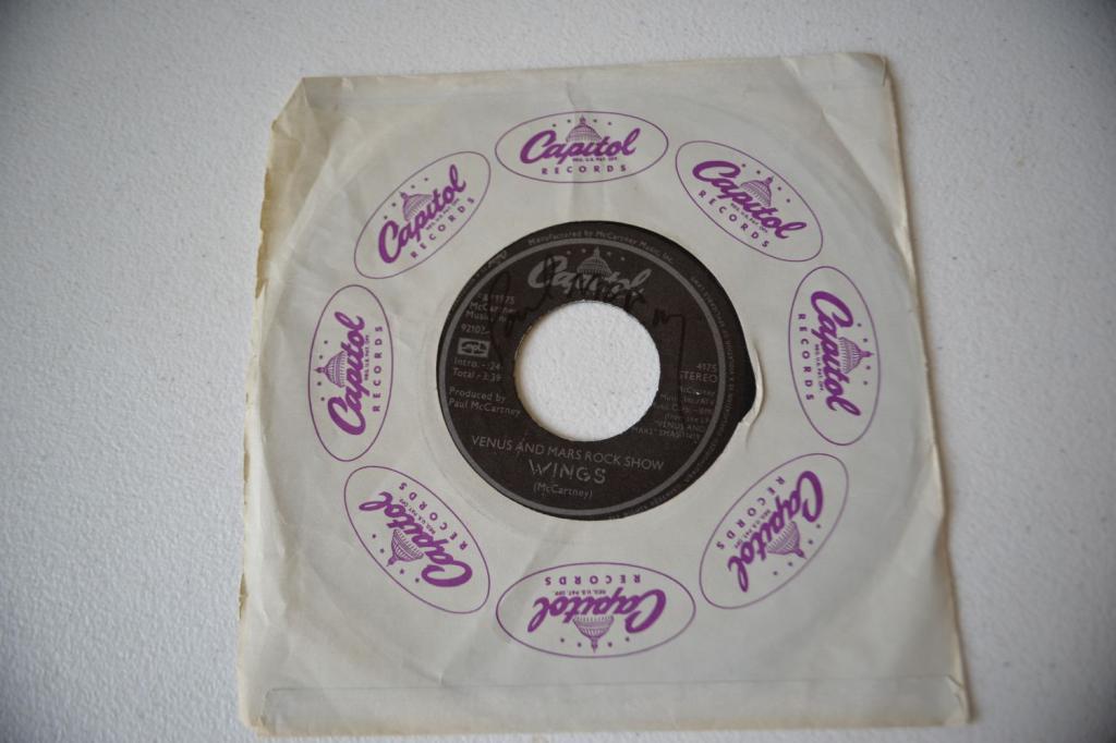 Signed Paul McCartney Wings 45 Record: Hand signed Paul McCartney 45 record of Wing's Venus and Mars Rock Show and Magneto and Titanium Man! Very good condition. This is from a credible consignor. We consider it to be genuine. Congratulati