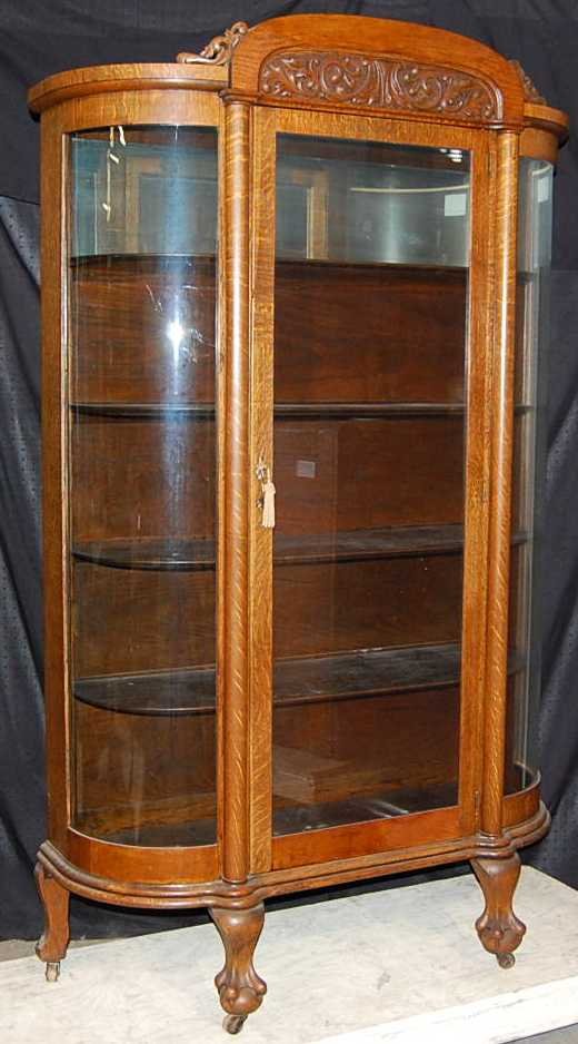 CARVED OAK CLAW FOOT AMERICAN VICTORIAN CHINA CABIN: VICTORIAN TIGER OAK, CARVED CREST, CLAW FEET, CURVED GLASS SIDES, FLAT FRONT,MIRROR IN TOP INSIDE, CA 1890, 46"W, 17"D, 76"TALL