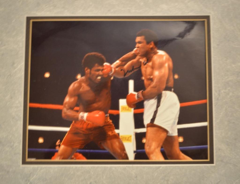 Muhammad Ali Signed vs Leon Spinks!: Muhammad Ali. 8”x10” signed color photo display double matted to 11”x14”. This is Ali's famous bout with Leon Spinks where he was defeated for the heavyweight Championship. Bef