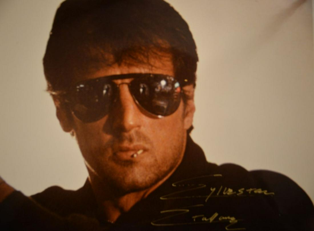 Sylvester Stallone Signed Photo. COA: Sylvester Stallone 8 x 10 inch head and shoulders color photograph nicely signed in gold ink. With Todd Mueller COA.