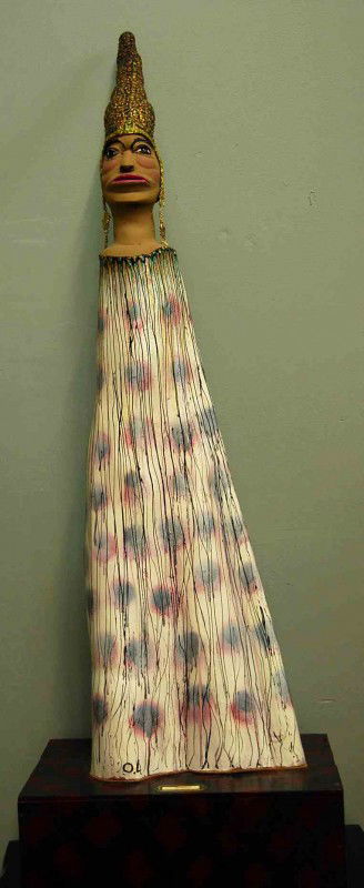 Folk Art Sculpture bu O.L. Samuels: Titled 'African Queen' standing 51 inches tall and 14 inches wide, sit on base that measures 20 inches wide, 13 inches deep and 7 inches tall. Our best guess, some sort of wood.