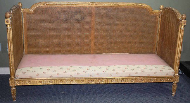 French Gilt Cane Day Bed: Early style with reeded columns and acorn finials. All cane is in good shape and frame is very sturdy. Measures 79 inches wide, 31 inches deep and 42 inches tall.