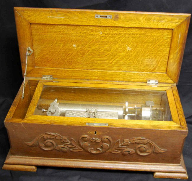 Antique Swiss Music Box : Swiss movement,nice oak case, no key. Appears mechanically sound and plays when rotated by hand however will not play on its own. Measures 24 inches wide 8 inches tall and 10 inches deep. Patented 186