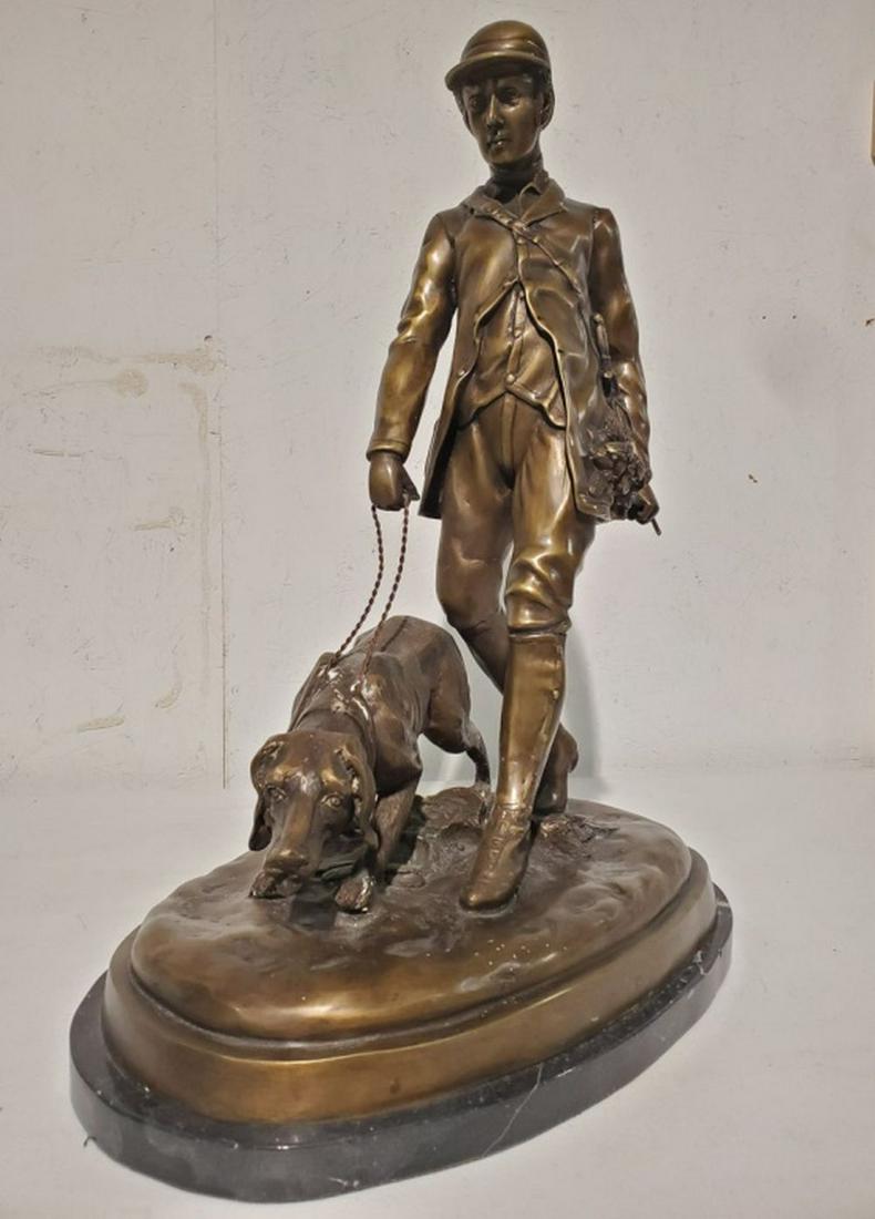 Antique Hunter and Hound Bronze Sculpture 25"H: Fantastic bronze sculpture of a hunter with his loyal hound on patrol for game. Great detail down to the hunter's boots and leaves on the ground. Really nice piece! Circa 1920. 25H x 19W x 12D inches.
