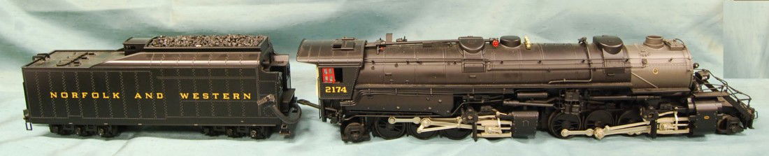 MTH O GAUGE 2-8-8-2 STEAM ENGINE w/ TENDER: STYLED AFTER NORFOLK AND WESTERN MODEL 2174, THIS AND OTHER MODELS FROM AN ATLANTA ESTATE. MEASUREMENTS ARE - ENGINE: 18 1/2 LONG AND 4 INCHES TALL WITH A 12 INCH LONG TENDER.