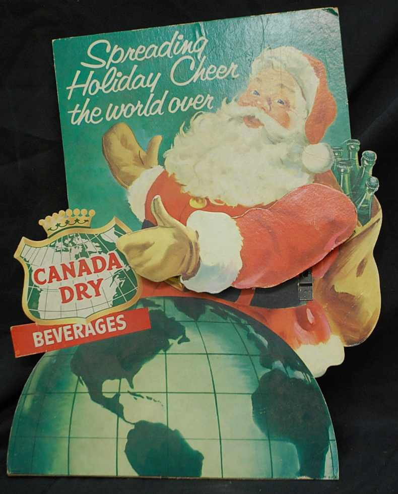 VINTAGE MECHANICAL SANTA SELLING CANADA DRY: CIRCA 1965. INCLUDES HANKSCRAFT PENDULUM FOR WAVING ARM. REQUIRES 'D' BATTERY. MEASURES 14.5 INCHES WIDE AND 17.5 INCHES TALL.