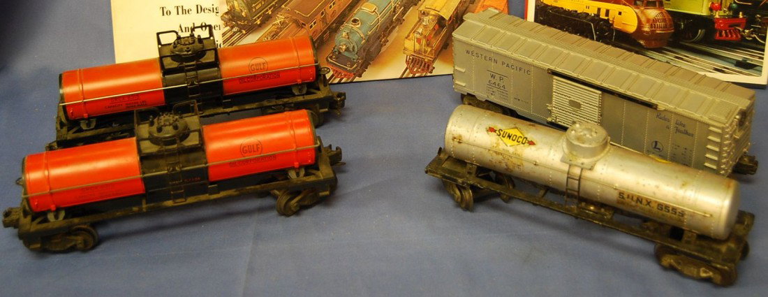 ODD LOT OF LIONEL TANKERS AND COLLECTOR BOOKS: 3 TANKS AND 1 WESTERN PACIFIC BOX CAR ALONG WITH 3 BOOKS ON THE HOBBY.