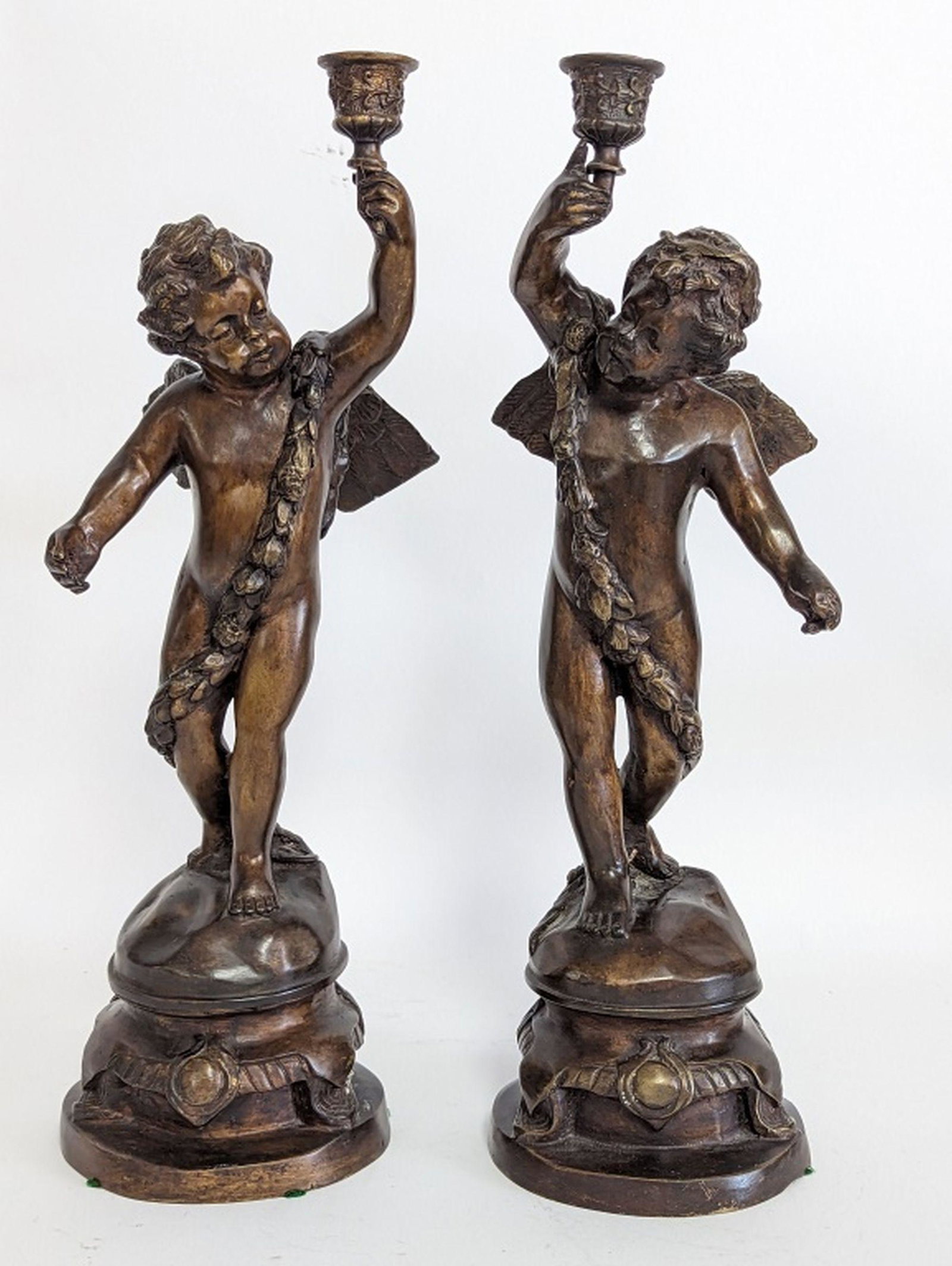 Fine Bronze Cherub Candleholders 16"H: Gorgeous and finely crafted cast bronze candleholders. Very good condition with applied patina. 16.25H x 6W x 6D inches.