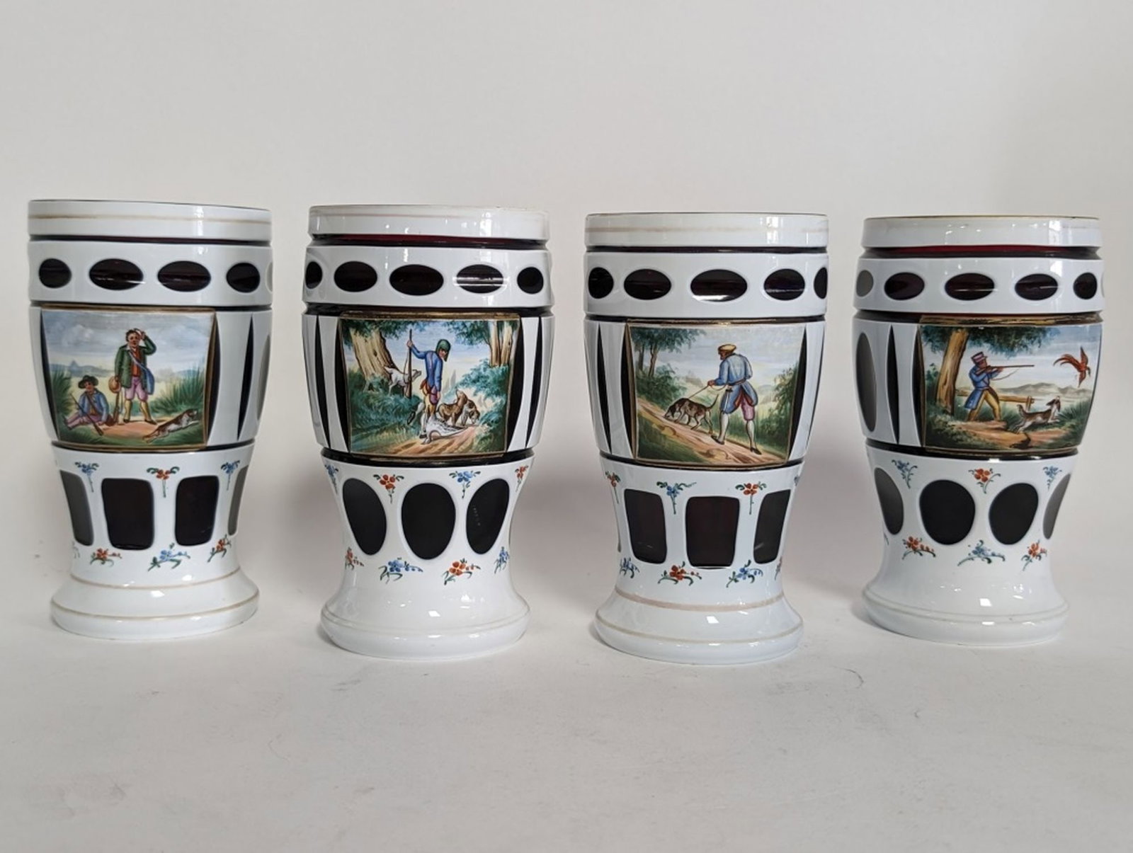4- Bohemian Glass Tumblers 6"H: 4- Bohemian glass tumblers with individual hunting scene on each. 6 in high. Expect to pay over $100 each online. Be sure to view all photos for condition.