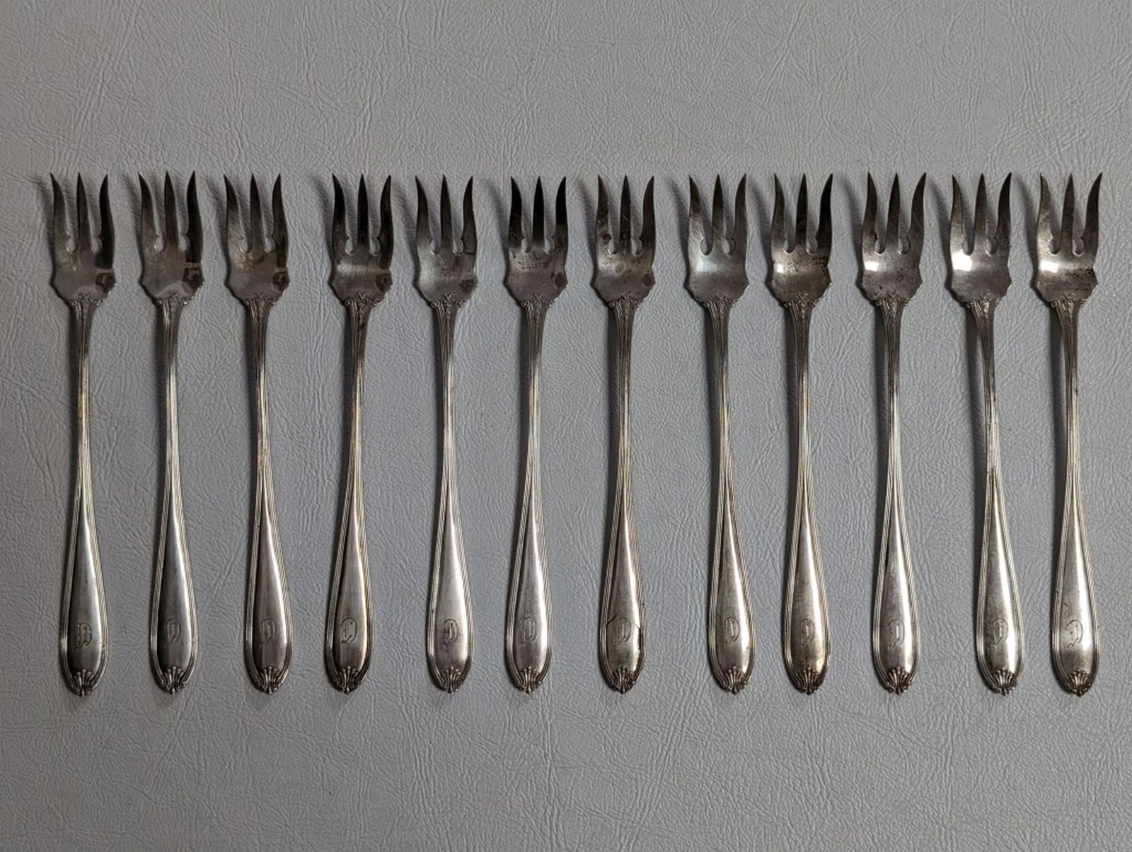 12 International Sterling Oyster Forks: Set of 12 International Silver Sterling, Margaret-Old pattern, Oyster Forks. 5 3/8 inches. - 158.3 grams total weight. Monogrammed. Good condition with normal wear.