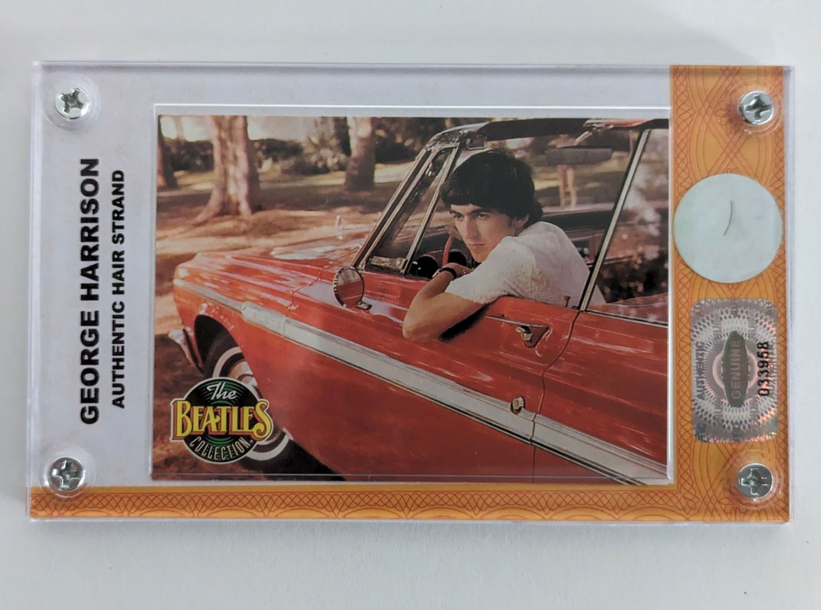 Beatles' George Harrison Hair Strand COA: This Limited edition Beatles Collection display consists of an individual single half-inch strand of hair from George Harrison, numbered 58. The strands of hair were taken from the lot that was origin