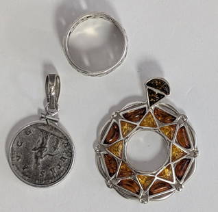 Lot of Sterling Silver Jewelry Pieces: Lot of 3 sterling silver jewelry pieces including an amber inset pendant, a coin pendant, and a ring. Beautiful pieces. All in good condition. Total weight: .56 oz.