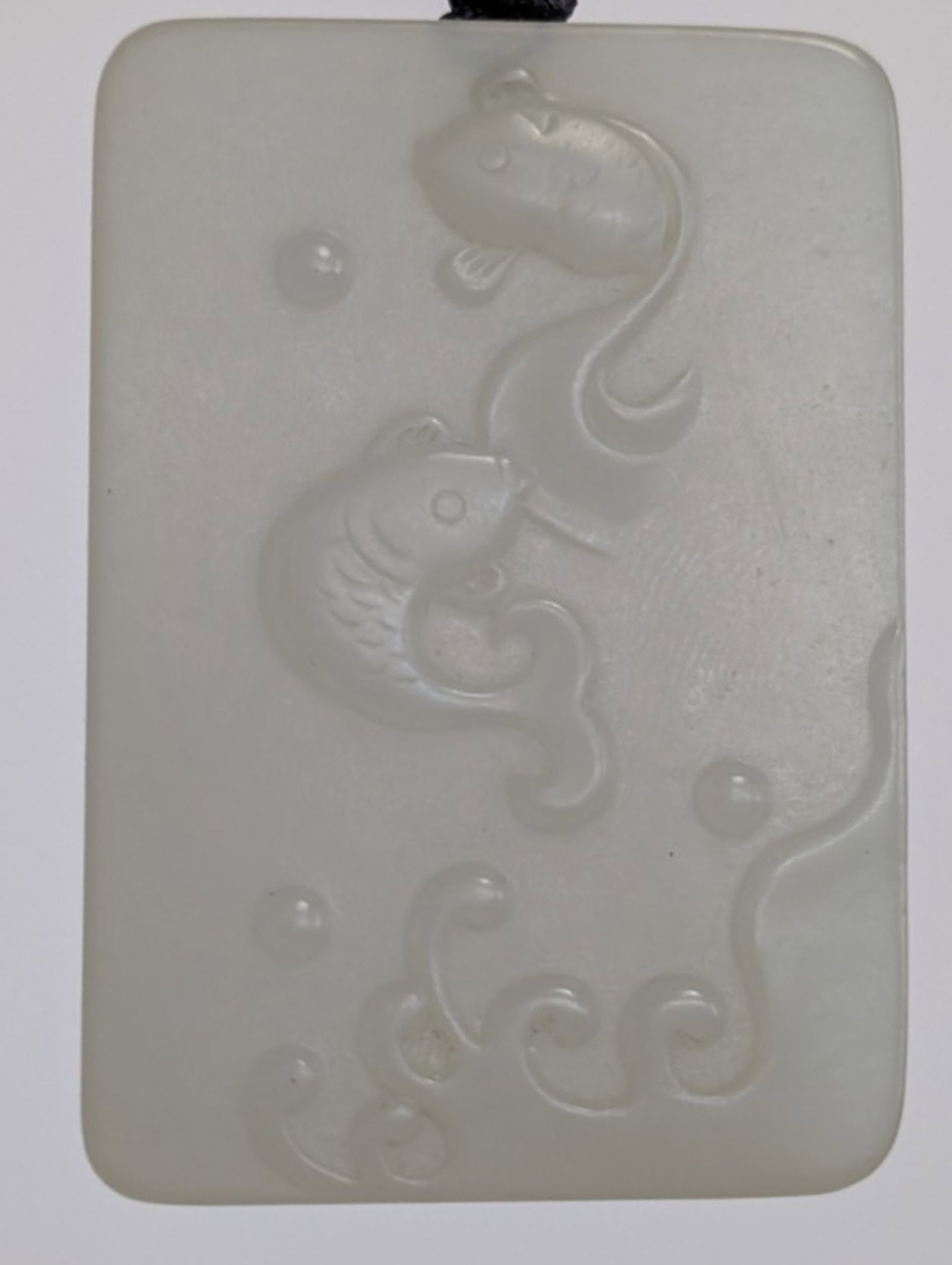 Antique Chinese Hetian Nephrite Jade Pendant: Lovely hand carved Chinese Nephrite Jade Pendant. One side with 2 fish and one side with mountain meaning for wealth and saving a lot. Very good condition. Please be sure and view all photos for condi