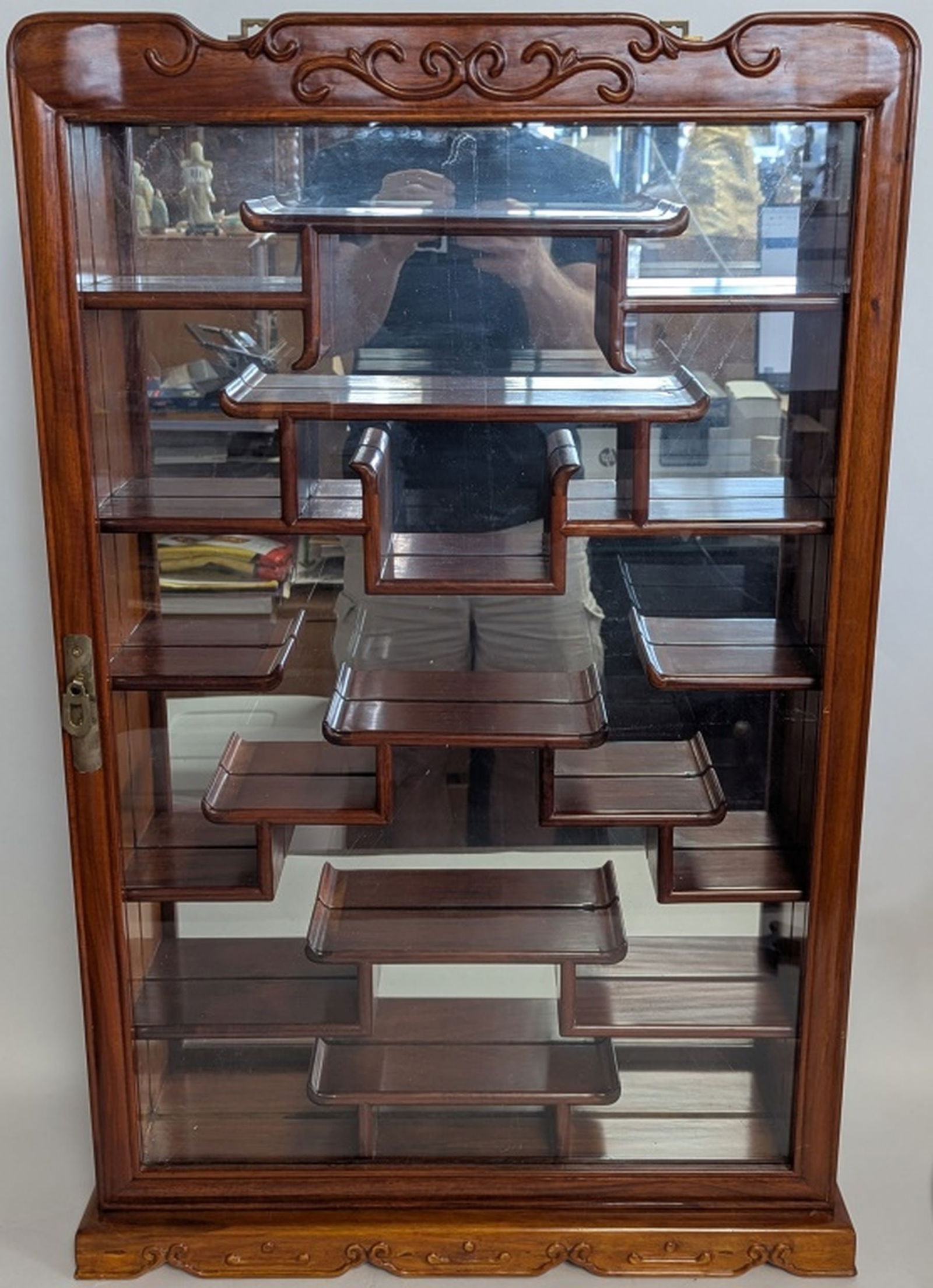 Vintage Asian Rosewood Curio Cabinet 32H": Fine Asian style mirror backed display cabinet in solid rosewood. 32H x 21W x 5D in. Brass hangers mounted on the back. In very good condition with minor wear. From a fine estate near Atlanta. Congrat