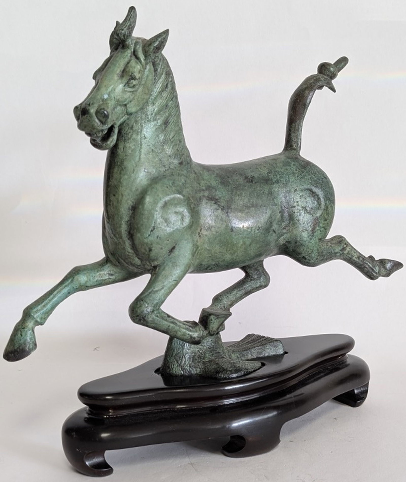 Fine Galloping Horse Sculpture 10.5H: High action cast metal, galloping horse sculpture. Lovely patinated bronze style patina. Mounted on solid wood stand. Wonderful accent piece for any room. 10.5H x 3.5W x 13.25D". Very good condition. 