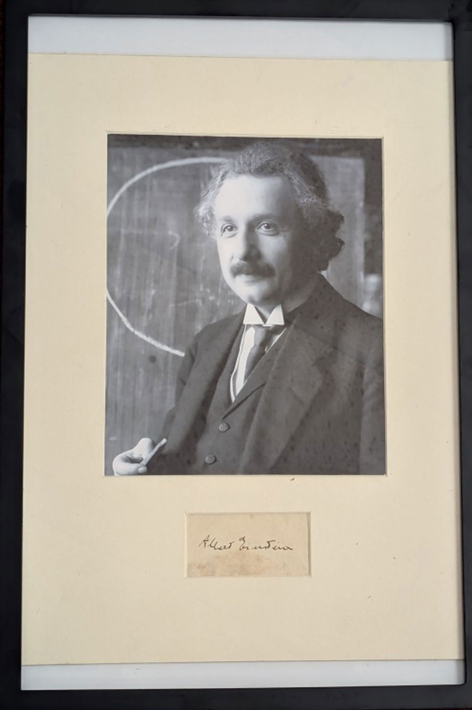 Albert Einstein Signature & Photo: Famous photograph of Albert Einstein taken in 1921 by photographer Ferdinand Schmutzer, likely during a lecture in Vienna over a hand signed autograph that reads Albert Einstein. Condition: Very good