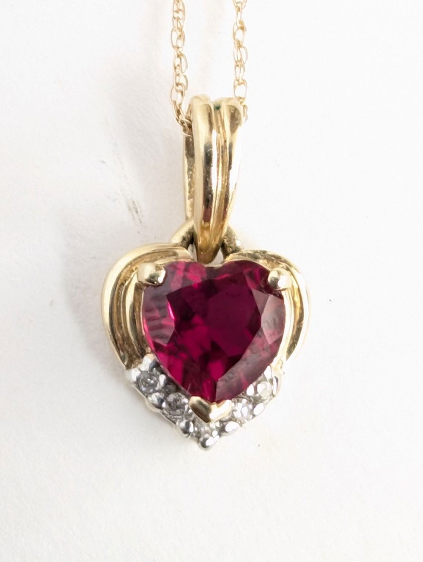 14K Ruby Diamond Necklace: Beautiful 14K Yellow Gold Ruby and Diamond Necklace. Very good in the box condition. 19 inch chain. Total weight 1.3 grams.