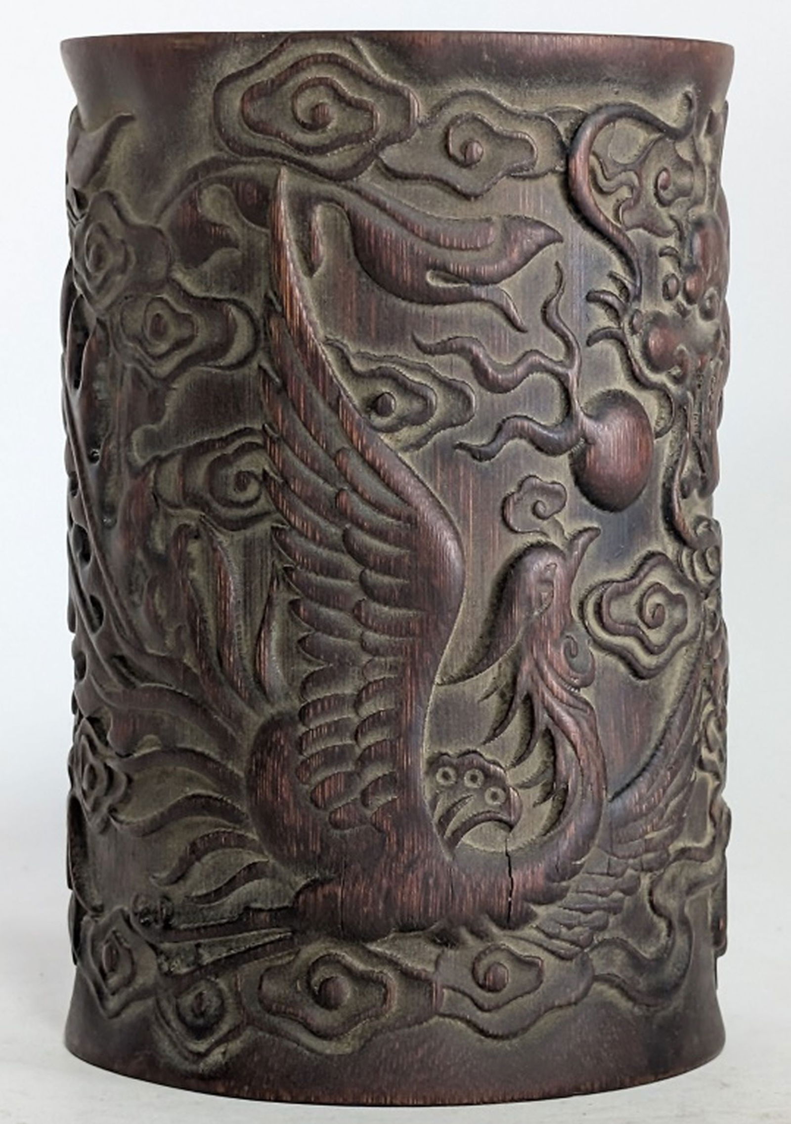 19thc Chinese Dragon & Phoenix Brush Pot: Chinese bamboo root carved dragon and phoenix brush pot or pencil vase. 6.5H x 4.5W in. It is finely carved in deep relief, depicting a dragon and a phoenix among clouds, symbolizing harmony and balan
